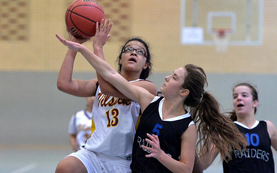 Vilseck's Vivian Tanner aims for the basket as Lara van der Merwe of International School of Brussels tries to defend. Vilseck beat ISB 33-13 in Division I action at the DODDS-Europe basketball championships in Wiesbaden, Germany, Thursday Feb. 20, 2014.