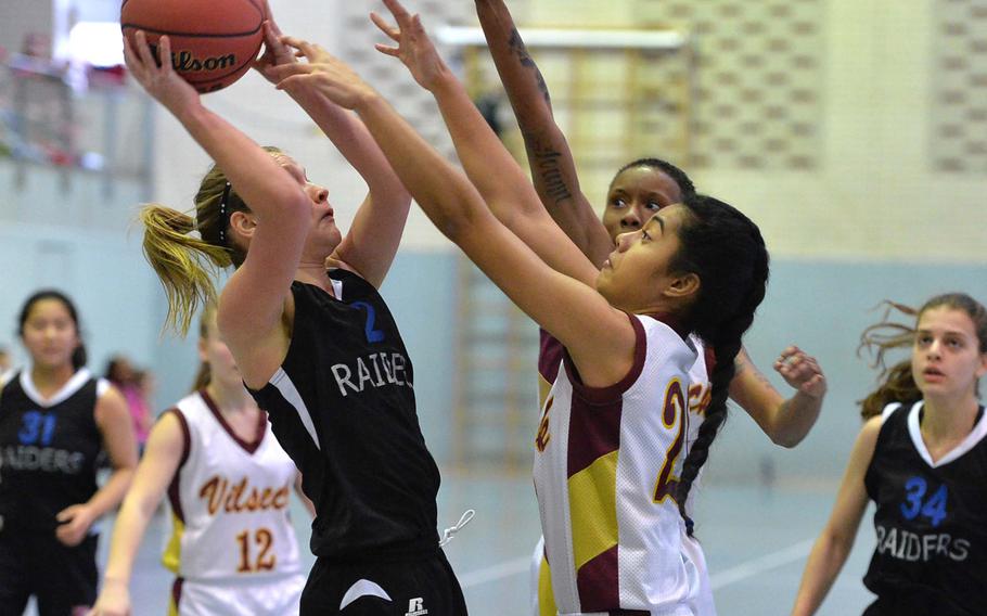 Kelsey Adamitis of International School of Brussels, left, tries to get a shot off against Vilseck's China Sumpter, center and Beth Siatini. Vilseck beat ISB 33-13 in Division I action at the DODDS-Europe basketball championships in Wiesbaden, Germany, Thursday Feb. 20, 2014.
