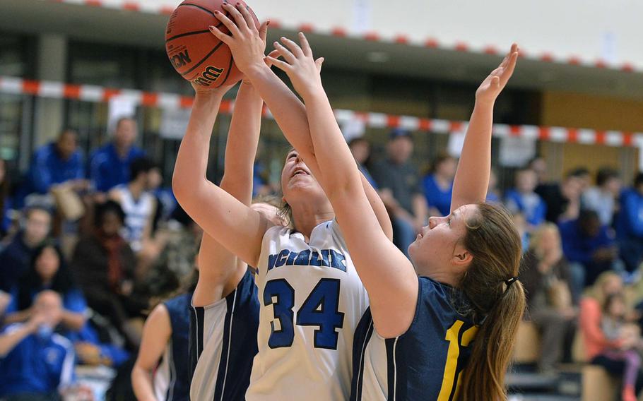 Incirlik's Brooke Willis attempts to get off a shot against the Lajes defense of Katie Czymbor, behind at left, and Enneleise Hirak, right, in Division III action at the DODDS-Europe basketball championships in Wiesbaden, Germany, Thursday Feb. 20, 2014. Incirlik won 31-10.