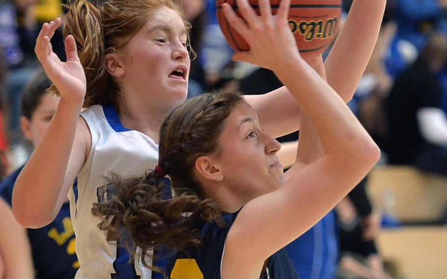 Alex Ciranni of Lajes aims for the basket after getting past Incirlik's Kortney Taylor in Division III action at the DODDS-Europe basketball championships in Wiesbaden, Germany, Thursday Feb. 20, 2014. Incirlik won 31-10.

Michael Abrams/Stars and Stripes





