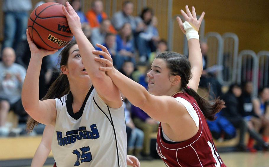 Ana-Marija Vasileva of Brussels looks for a shot against Menwith Hill's Ramie Ogea in a Division III semifinal at the DODDS-Europe basketball championships in Wiesbaden, Germany, Friday Feb. 21, 2014. Brussels won 26-9 and will face Sigonella in Saturday's final.