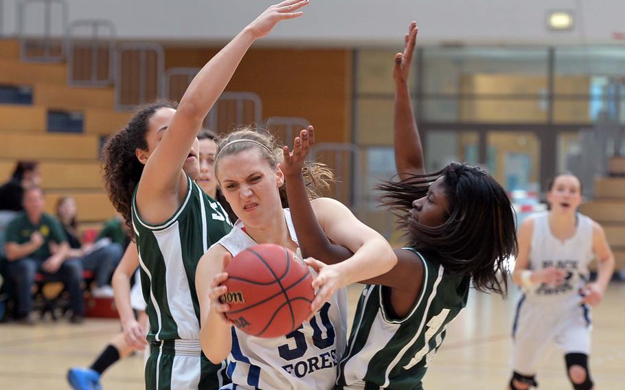 Black Forest Academy's Abby Eucker gets caught up in the SHAPE defense of Ryan Paine, left, and Gina Rhett in a Division II semifinal at the DODDS-Europe basketball championships in Wiesbaden, Germany, Friday Feb. 21, 2014. BFA won 36-18 to advance to Saturday's final. 




