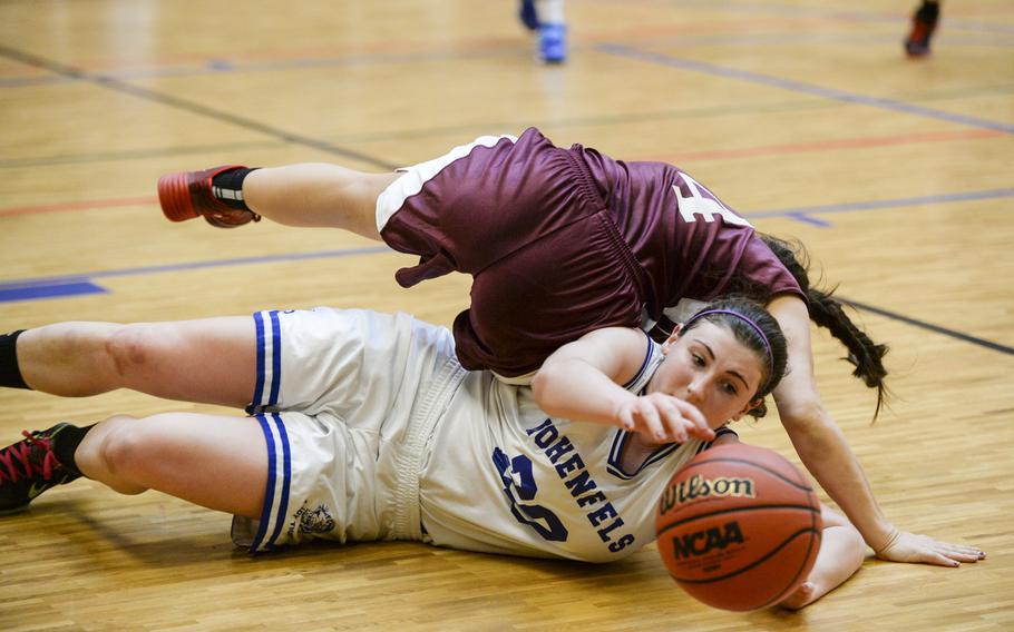 Hohenfels' Amelia Heath gains control of the ball against AFNORTH's Jena Solorzano in a DODDS-Europe basketball championships Division III semifinal game Friday, Feb. 21, 2014. AFNORTH came back to defeat Hohenfels 22-19.