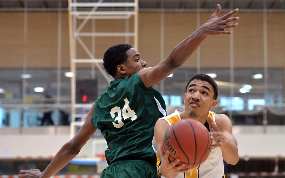 Vicenza's Derrick Schaefer, right, goes to the basket against SHAPE's Armond Griebe in a Division II semifinal at the DODDS-Europe basketball championships in Wiesbaden, Germany, Friday Feb. 21, 2014. Vicenza won 57-49 to advance to Saturday's final.