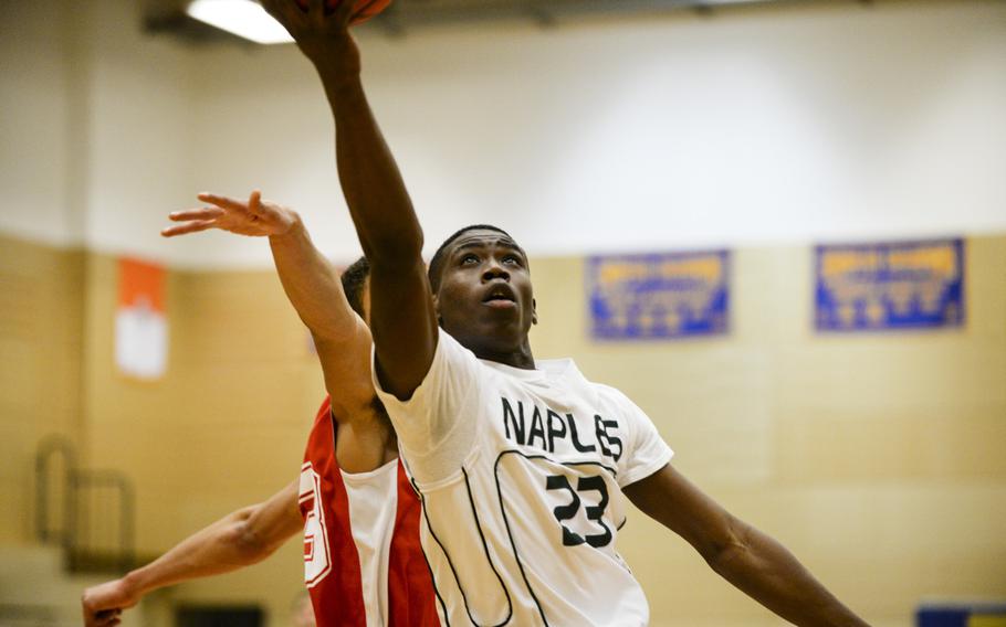 Naples' Jayontray Grogan drives to the basket in a DODDS-Europe basketball championships Division II semifinal game Friday, Feb. 21, 2014.