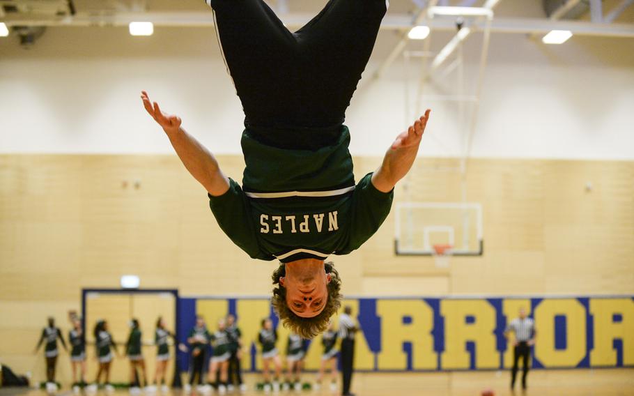 Naples cheerleader Austin Bain performs a backflip during a break in action at a DODDS-Europe basketball championships Division II semifinal game Friday, Feb. 21, 2014 at Wiesbaden, Germany.