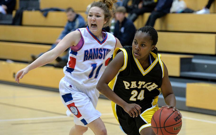 Patches' Janiece Loney drives towards the basket after getting past Ramstein's Zania Sterling in a Division I semifinal at the DODDS-Europe basketball championships in Wiesbaden, Germany, Friday Feb. 21, 2014. Patch won 49-36 to advance to Saturday's final.
