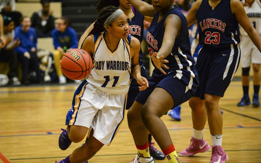 Wiesbaden's Cierra Martin takes the ball past a pressing Lakenheath in a DODDS-Europe basketball championships Division I semifinal game Friday, Feb. 21, 2014 at Wiesbaden, Germany. Wiesbaden beat Lakenheath 33-26.