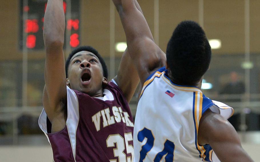 Vilseck's Daryl White shoots over Wiesbaden's Andrew Murray in a Division I semifinal at the DODDS-Europe basketball championships in Wiesbaden, Germany, Friday Feb. 21, 2014. Wiesbaden won 69-50 to advance to Saturday's final against Patch.