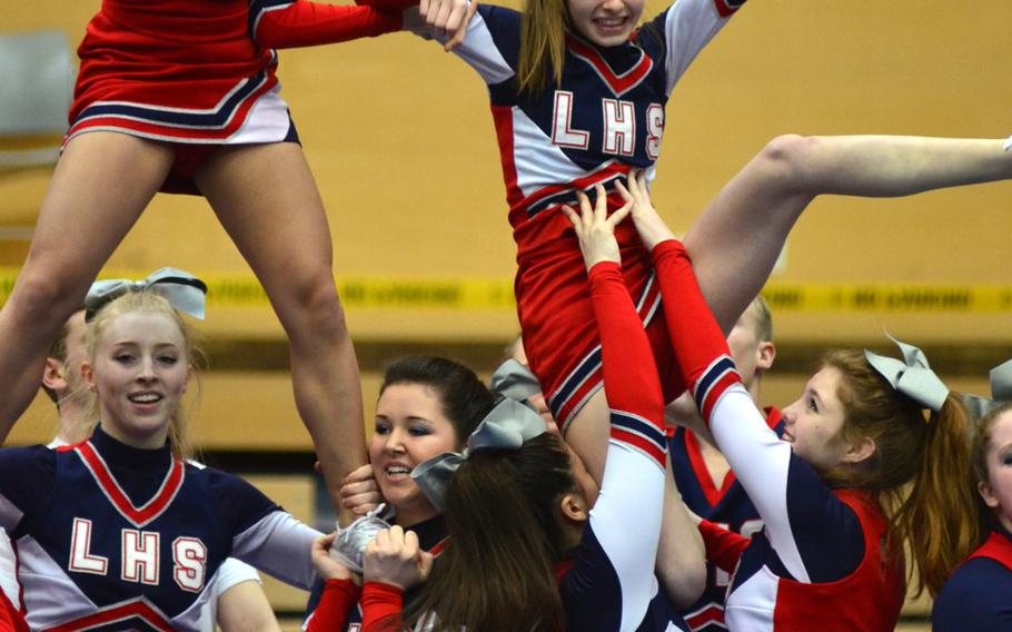 The Lakenheath Lancers cheer squad performs part of their 2 minute routine at the DODDS-Europe cheerleading championships in Wiesbaden, Germany, Saturday Feb. 22, 2014. 