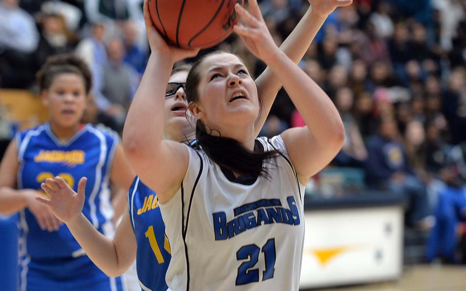 Teodora Vasileva of Brussels scores the go-ahead basket against Aiden Adriano in her team's 38-31 overtime win over Sigonella in the Division III girls final at the DODDS-Europe basketball championships in Wiesbaden, Germany, Saturday, Feb. 22, 2014.