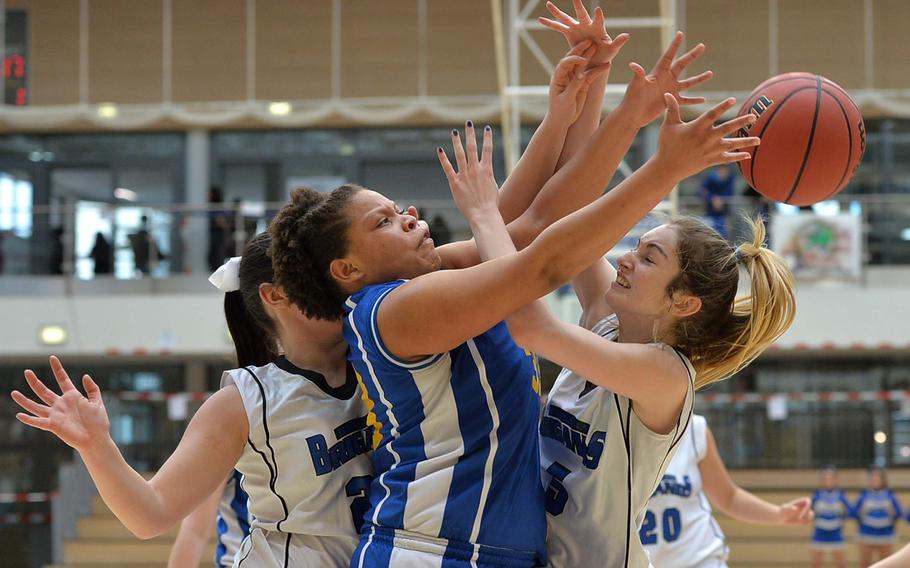 Sigonella's Sydney Moore collides with Aleeza-Maria Vitale of Brussels as they fight for a rebound in the Division III girls final at the DODDS-Europe basketball championships in Wiesbaden, Germany, Saturday, Feb. 22, 2014. Brussels won 38-31 in OT. At far left is Teodora Vasileva.