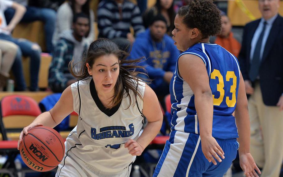 Ana-Marija Vasileva of Brussels drives against Sigonella's Sydney Moore in the Division III girls final at the DODDS-Europe basketball championships in Wiesbaden, Germany, Saturday, Feb. 22, 2014. Brussels won 38-31 in OT.
