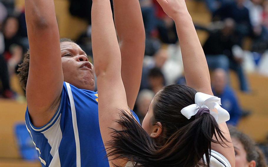 Sydney Moore of Sigonella shoots over Teodora Vasileva of Brussels in the Division III girls final at the DODDS-Europe basketball championships in Wiesbaden, Germany, Saturday, Feb. 22, 2014. Brussels won 38-31 in OT. 