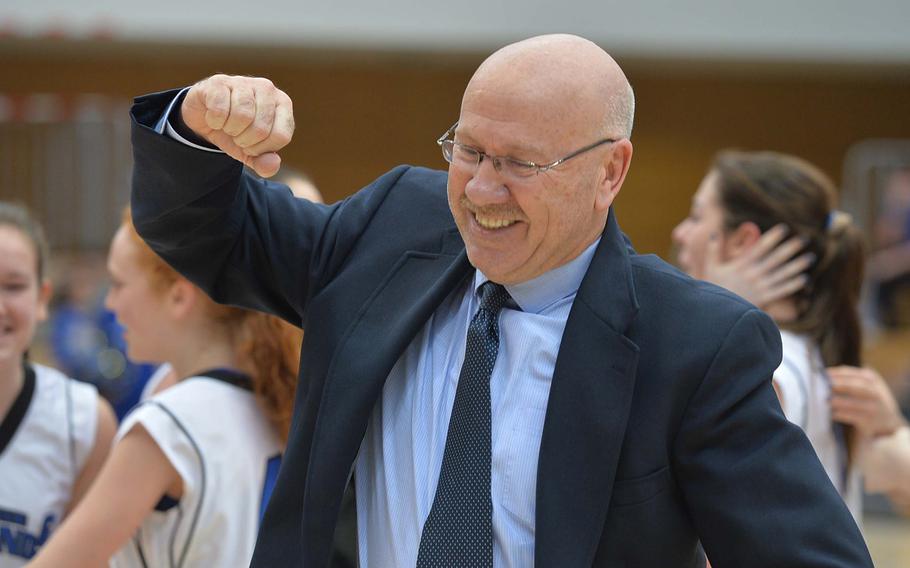 Brussels coach Tim Como celebrates his team's 38-31 overtime win over Sigonella in the Division III girls final at the DODDS-Europe basketball championships in Wiesbaden, Germany, Saturday, Feb. 22, 2014.