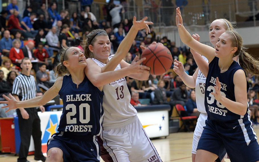 Black Forest Academy's Elyssa Brauer, left, fights for a rebound with AFNORTH's Grace Phillips as teammates Mariell Prestmo and Abby Eucker, right, watch in the Division II final at the DODDS-Europe basketball championships in Wiesbaden, Germany, Saturday, Feb. 22, 2014. BFA beat AFNORTH 19-13.