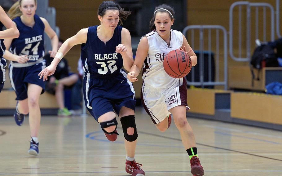 AFNORTH's Jena Solorzano drives the ball up the court against Black Forest Academy's Hannah Harrop in the Division II final at the DODDS-Europe basketball championships in Wiesbaden, Germany, Saturday, Feb. 22, 2014. BFA won 19-13.
