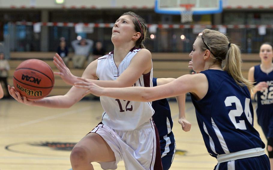 AFNORTH's Eliska Volencova gets past Black Forest Academy's Brianne Riff  in the Division II final at the DODDS-Europe basketball championships in Wiesbaden, Germany, Saturday, Feb. 22, 2014. BFA won 19-13.
