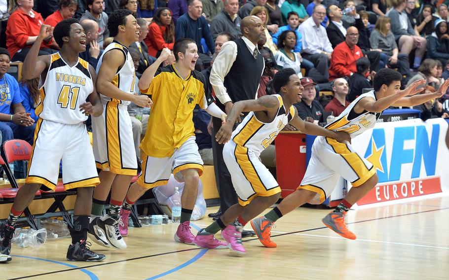 The Vicenza Cougars starters and bench storm the court at the buzzer after they defeated Naples 75-45 in the Division II title game at the DODDS-Europe basketball championships in Wiesbaden, Germany, Saturday, Feb. 22, 2014.