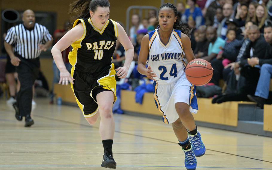 Wiesbaden's Phylecia Faublas drives the ball up the court against Patch's Rebecca Hess in the Division I title game at the DODDS-Europe basketball championships in Wiesbaden, Germany, Saturday, Feb. 22, 2014. Wiesbaden beat Patch 40-17.