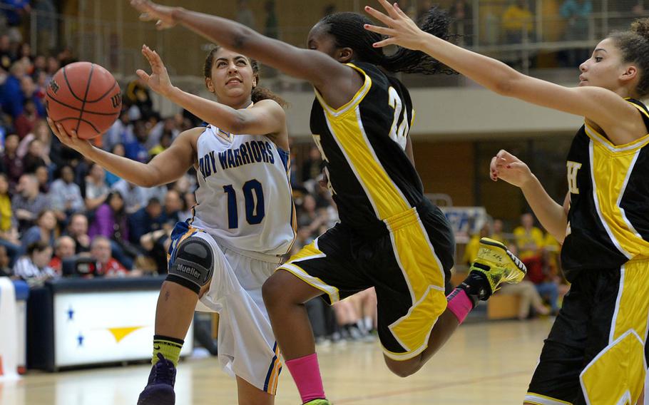 Wiesbaden's Sydney Hill goes to the basket against Patch's Janiece Loney in the Division I title game at the DODDS-Europe basketball championships in Wiesbaden, Germany, Saturday, Feb. 22, 2014. Wiesbaden beat Patch 40-17. Coming in to help at right is Meisha Blue.
