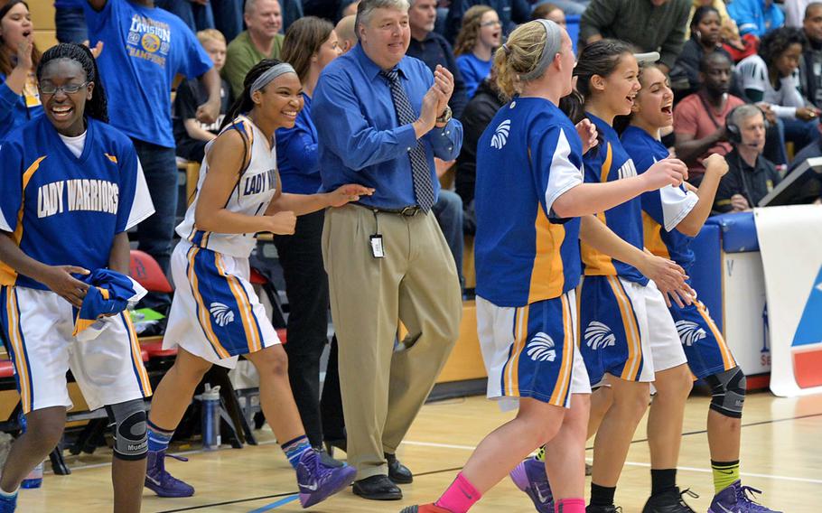 The Wiesbaden Warriors with coach Jim Campbell celebrate their Division I title after defeating Patch 40-17 at the DODDS-Europe basketball championships in Wiesbaden, Germany, Saturday, Feb. 22, 2014. 