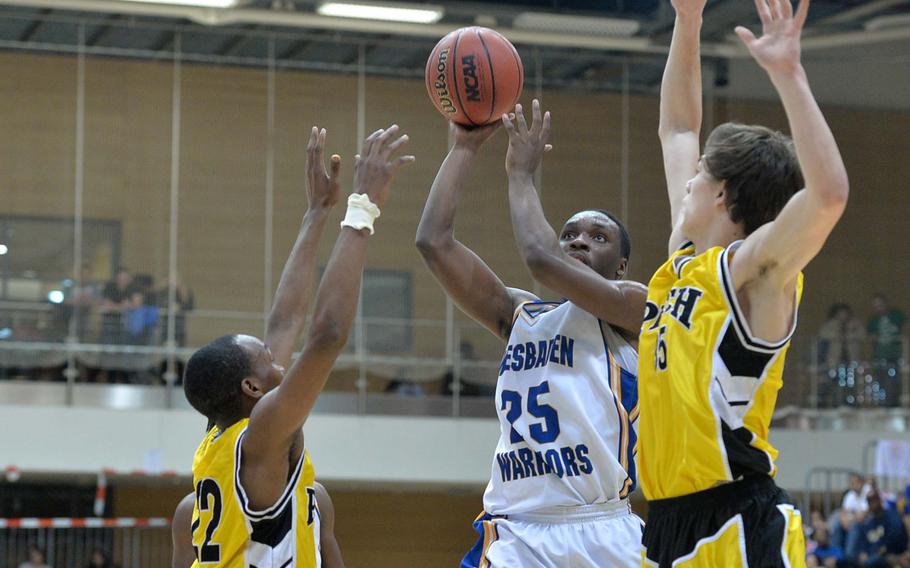 Wiesbaden's Anthony Little shoots against the Patch defense of Kelvin Brown, left, and Holten Sparling in the Division I title game at the DODDS-Europe basketball championships in Wiesbaden, Germany, Saturday, Feb. 22, 2014. Patch beat the Warriors 60-56.
