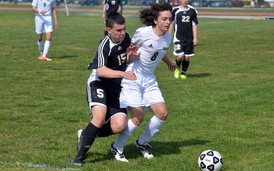 Vicenza freshman defender Christian Gallegos, left, vies with sophomore David Laird for possession during a March 15, 2014, game between Naples and Vicenza. Naples won the match, the first of the season, 4-1. 