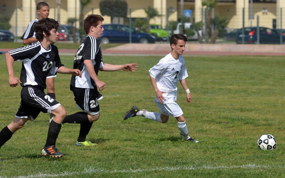 Naples sophomore Davide DiCostanzo, right, breaks away from Vicenza defenders during a March 15, 2014, match in Naples. The Wildcats defeated the Cougars 4-1.  