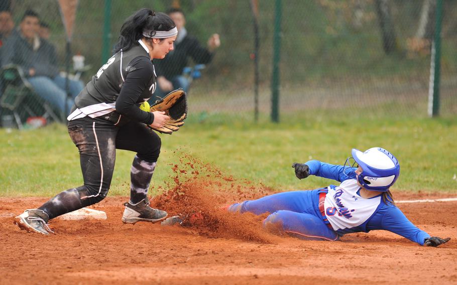 Vilseck's Tania Powers pulls in a throw in time to get Ramstein's Brea Monahan out at third in the second game of a doubleheader at Ramstein, Germany, Saturday, March 22, 2014.