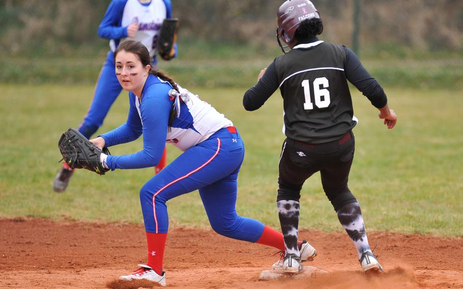 Ramstein's Alexis Weathers looks for a play at first base after getting Vilseck's Shay Shannon out at second in the second game of a doubleheader at Ramstein, Germany, Saturday, March 22, 2014.