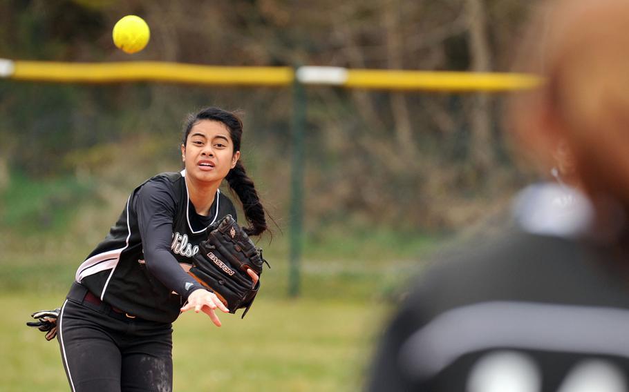 Vilseck's Beth Siatini throws to Emily Lebel at first base, in the second game of a doubleheader at Ramstein, Germany, Saturday, March 22, 2014.