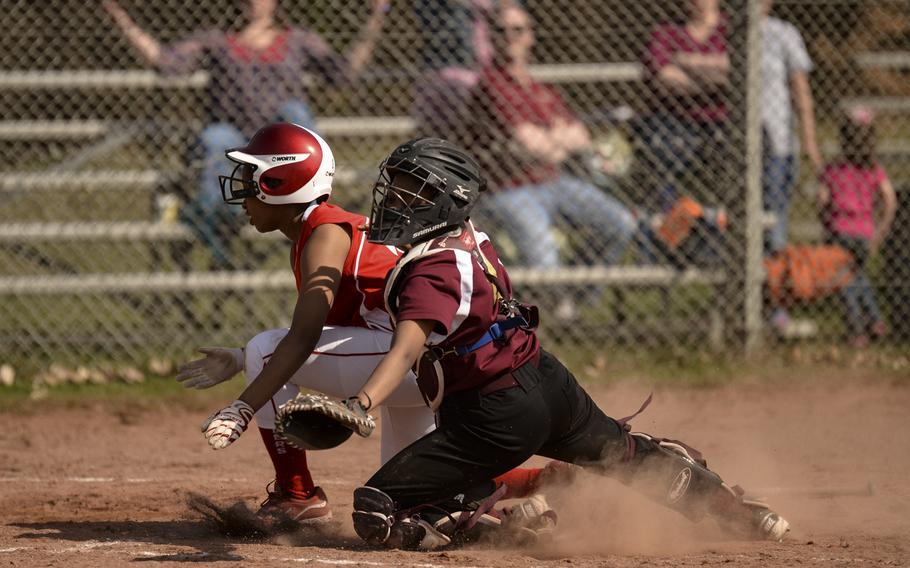 Kaiserlautern's Autum Linder collides with Baumholder's Breauna Kimbrough as she scores an in-the-park homerun in the first game of a double header against Baumholder Saturday, March 29, 2014 at Kaiserlautern, Germany.