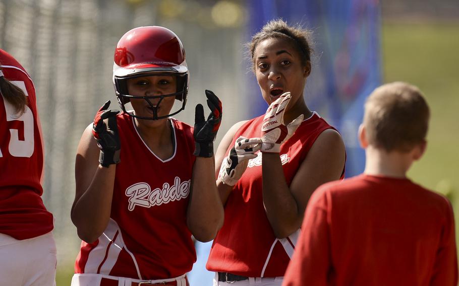 Kaiserslautern's Sydney Brown, left, and Autum Linder react after Brown scored a run in a double header against Baumholder Saturday, March 29, 2014 at Kaiserslautern, Germany.