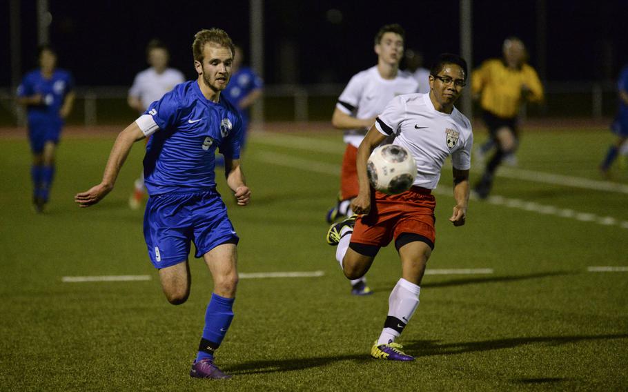 Ramstein's Cameron Hansen chases the ball down Thursday night, April 3, 2014 at Kaiserslautern, Germany.
