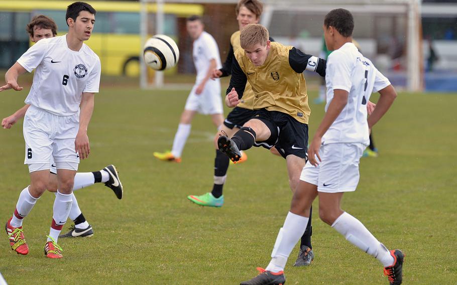 Patch's Christian Rauschenplat gets off a shot in his team's 0-0 tie with Ramstein Friday, April 18, 2014. At left is Brienno Illari, at right, Damon White.

