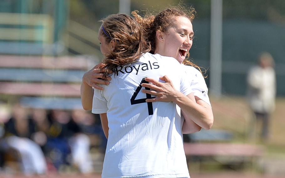 Ramstein's Lakyn Parker, left, hugs Hunter Pace after Pace scored the first of her two goals in Ramstein's 4-3 win over Patch Friday, April 18, 2014.