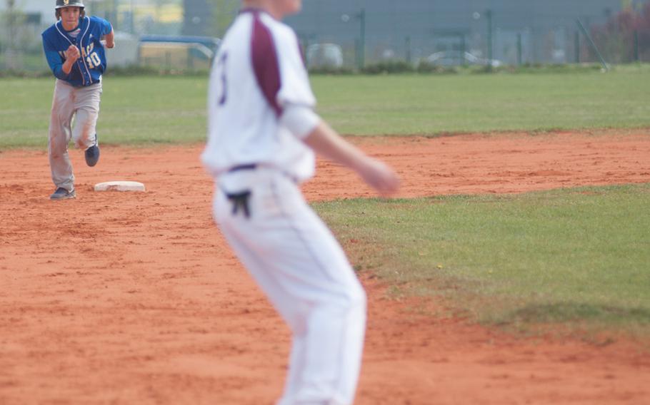 Ansbach's Samuel Rodriguez makes a dash for third as Baumholder third baseman Taylor Moore waits for the throw during a doubleheader Saturday at Ansbach, Germany. Ansbach took both games 17-0, 13-2.