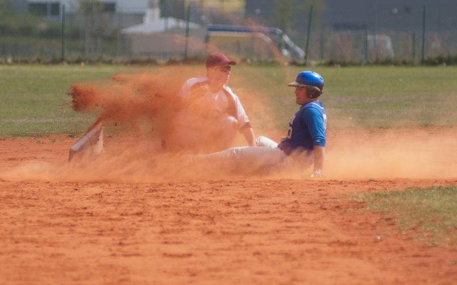 Ansbach's pitcher Austin Benton sends second base flying during a doubleheader against Baumholder Saturday at Ansbach, Germany. Ansbach took both games 17-0, 13-2.
