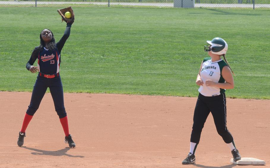 Aviano shortstop Ashley Mills catches a fly ball, while Naples' Erin Dromerhauser looks on from second base Friday, during a doubleheader game at Aviano Air Base, Italy. Naples won both games 19-10, 18-12. 
