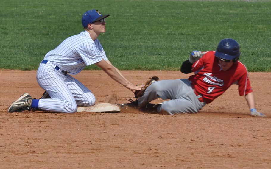 Sigonella shortstop Mason Youberg applies the tag to Aviano's Scott Henshaw, who was called out in the second inning of the Jaguars' 8-4 victory over the Saints on Saturday.