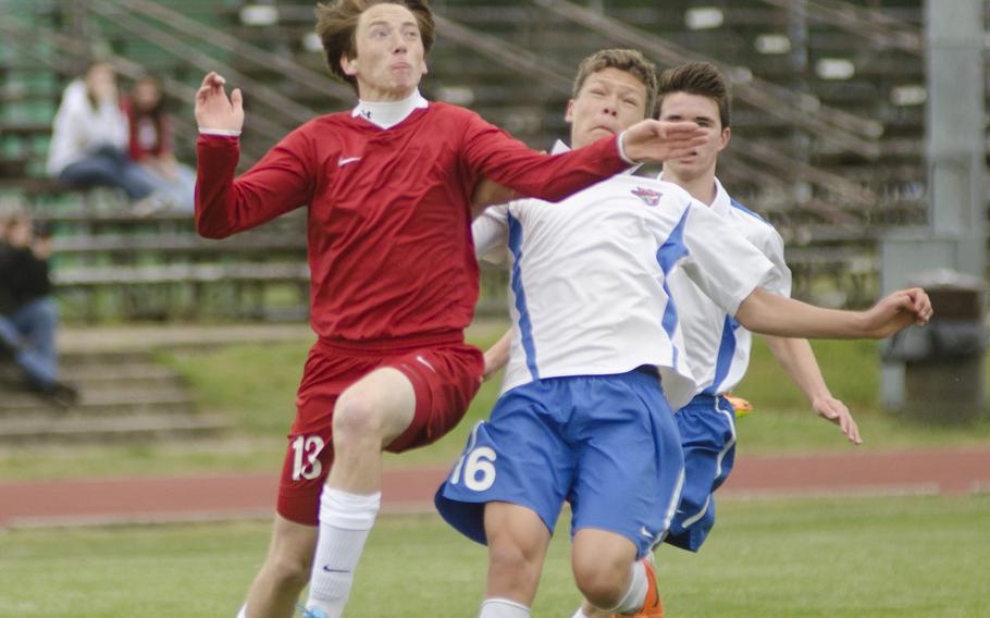 Lakenheath's Chris Miles vies for the ball with ISB's Adriaan Keurhorst during a boys soccer game on Saturday, May 3, 2014. Lakenheath would eventually win the game 2-1.
