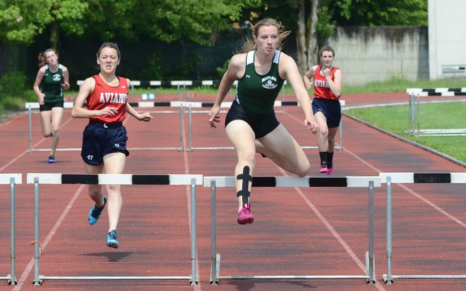 Naples' Amelia Chaston attempts to clear a hurdle Saturday, during a 300-meter hurdle track and field event at Creazzo, Italy, while Aviano's Riley Fulton nears. Chaston finished first in 53.95 seconds, followed by Fulton in 54.73.