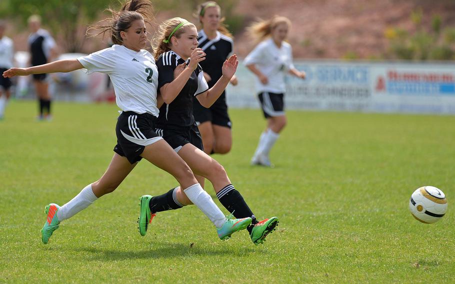 Jill Thurston of Naples, left, centers the ball against the defense of Vicenza's Tory Brock in a Division II semifinal game at the DODDS-Europe soccer championships in Reichenbach, Germany, Wednesday, May 21, 2014. Naples won 5-2 and will meet AFNORTH in the championship game on Saturday.