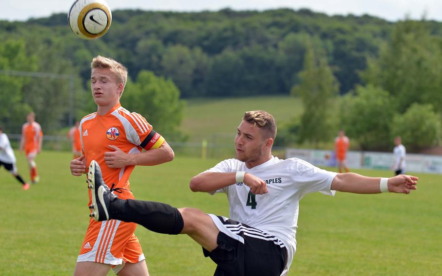 Matteo Pugliese of Naples clears the ball in front of AFNORTH's Claudius Karich in a Division II semifinal game at the DODDS-Europe soccer championships in Reichenbach, Germany, Wednesday, May 21, 2014. 
AFNORTH won the game 5-1 and will meet Marymount in Saturday's championship game.
