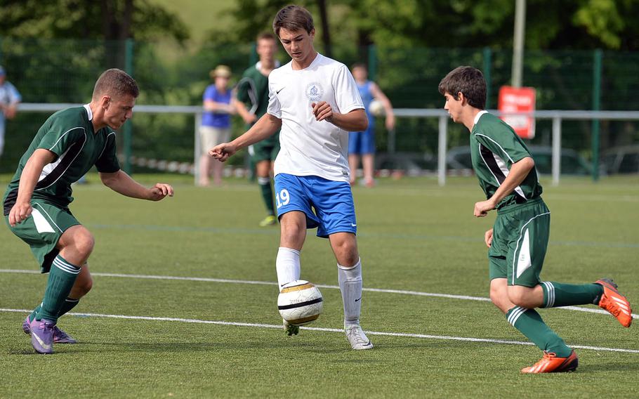 Marymount's Alessandro Anzillotti sends a pass between SHAPE's Patrick Zvirinsky, left, and Fernando Palau in a Division II semifinal game at the DODDS-Europe soccer championships in Reichenbach, Germany, Wednesday, May 21, 2014. Marymount won the game 3-1 and will face AFNORTH in Saturday's championship game.
