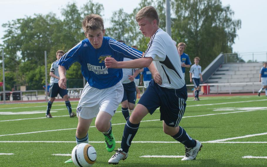 Sigonella's Kyle Marshall drives past Menwith Hill's Casey Lambert in a Division III semifinal game at the DODDS-Europe soccer championships at Kaiserslautern, Germany, May 21, 2014. The Jaguars beat Menwith Hill, 5-4 and will face Brussels in the finals on Thursday. 


