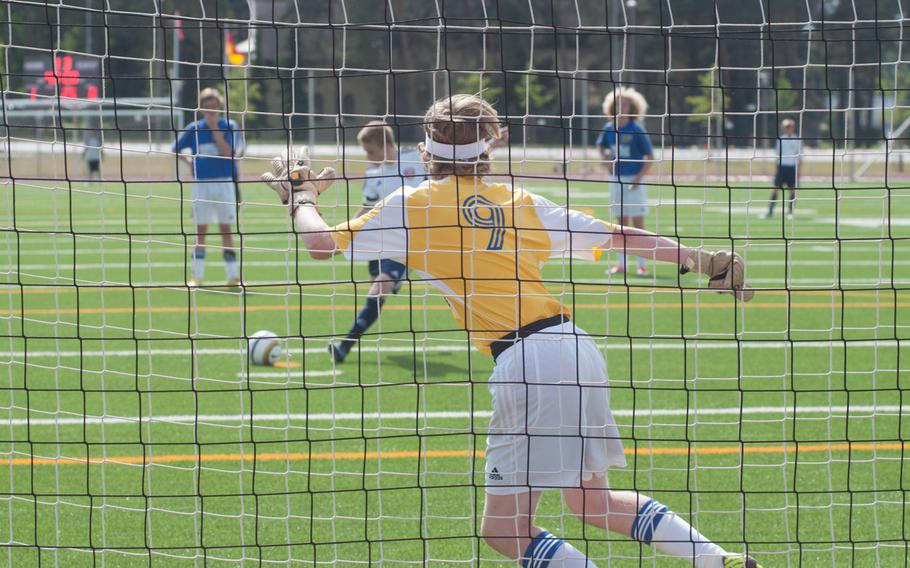 Menwith Hill's Shaun Brooks scores on a penalty kick against Sigonella during a Division III semifinal game at the DODDS-Europe soccer championships at Kaiserslautern, Germany, May 21, 2014. Brooks scored two goals, but his team was unable to come away with the victory, as Sigonella won 5-4. 