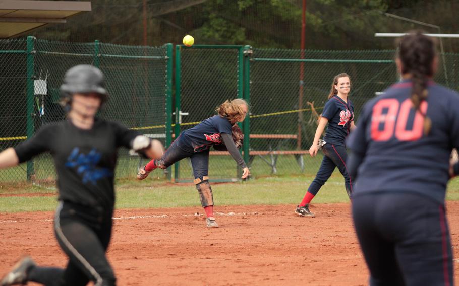 After fielding a trickling grounder near third base, Bitburg pitcher Alexa Landenberger throws to first in an attempt to throw out Hohenfels' Mikaela Strange during day two pool play in the DODDS-Europe softball championships Friday. 