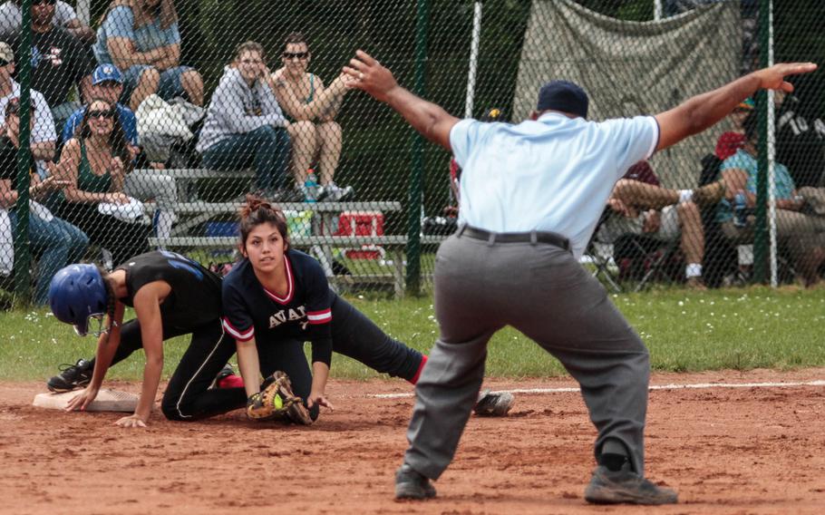 Aviano's Sabrina Huerta looks up to see the umpire call Hohenfels' Brooke Bean safe at third after the Lions sophomore smacked a looping triple to center field Friday in the DODDS-Europe softball championships. 